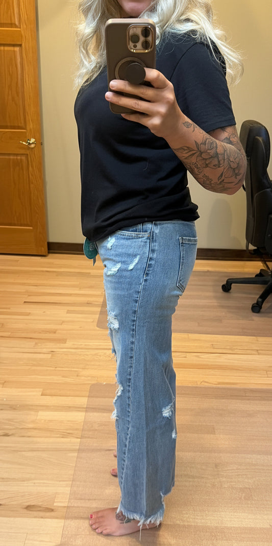 Brooke wearing Blakeley Drew distressed wide leg dad jeans in light wash size 1, side view showing mid-high rise waist and wide leg silhouette