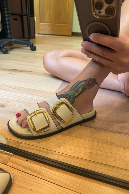 "Corkys Private Jet cream double-buckle sandal with silver buckles and black outsole"